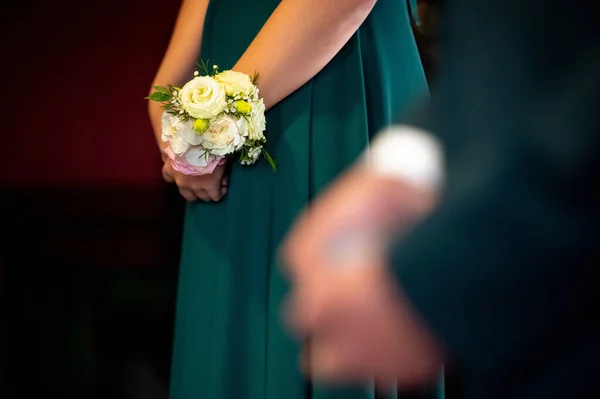 hands, wedding rings and marriage vows woman's hands in a green dress with flowers on her wrist