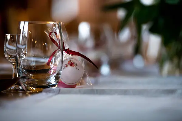 tableware and table decorations at celebrations a gift of macaroons on the table with white tablecloth and glass