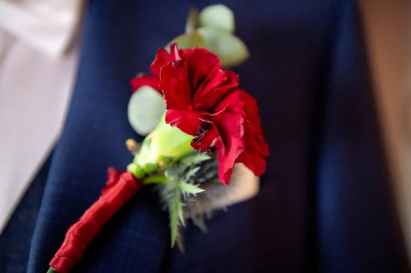 flowers bouquets bouquets and boutonnieres red flower in boutonniere and navy blue jacket