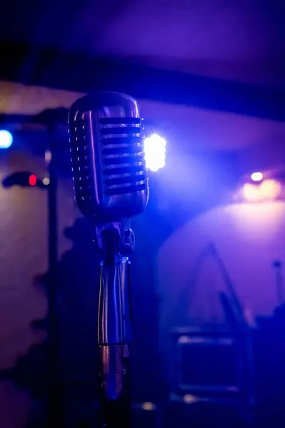 retro style microphone on stage lights background