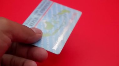 Kırmızı arka plana yerleştirilmiş Endonezya kimlik kartı