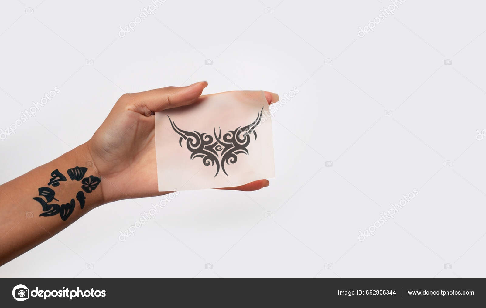 Hand Holding Temporary Tattoo Paper Isolated Soft White Background