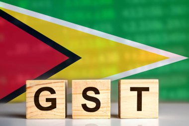 GST, Guyana bayrağı geçmişi olan tahta harf bloklarında sergileniyor. Vergi kavramı. resimleme tasarımı