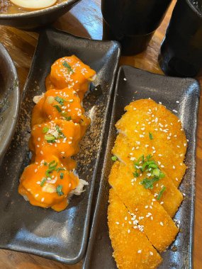 Restoran masasında güzel kaseler içinde Japon yemekleri.