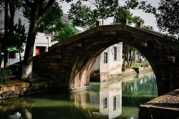 stock image Small river, wooden boats, stone bridges and old street wooden shops paved with stone bricks in a small water town in southern China