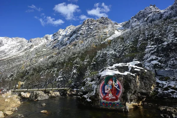 stock image Painted stone carvings of Tibetan Buddha statues in the high mountains of Western Sichuan, China, very majestic