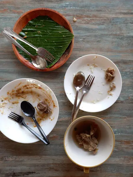 stock image top view of a plate with a fork and a knife on a wooden background