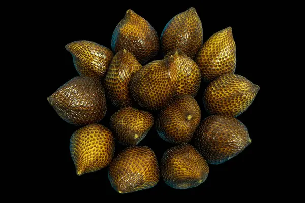 Irresistible reds of juicy Snake fruits isolated on black background with clipping path