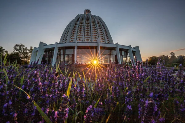 stock image The Bahaitum, Temple Church or House of Worship behind blooming lavender fields with sun star in the morning. Hofheim, Taunus, Germany