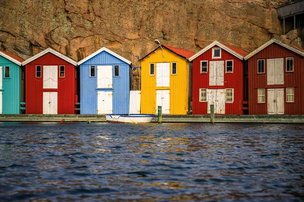 Sweden houses, small colorful fishermen\'s houses in Sweden smog. A great city right by the sea with a rock in the background