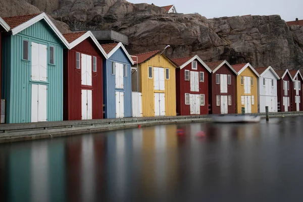 Sweden houses, small colorful fishermen\'s houses in Sweden smog. A great city right by the sea with a rock in the background