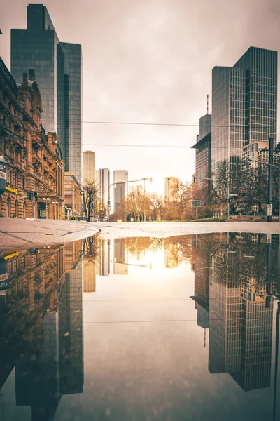 stock image rankfurt am Main in Germany. City view in a street with skyline and skyscrapers. These are reflected in a puddle