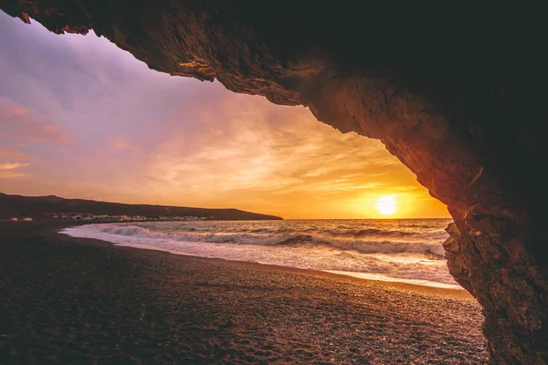 stock image Sunrise or sunset in Fuerteventura Canary Islands. On the beach with stones and long exposure. unique light. Pure holiday feeling. fine clouds