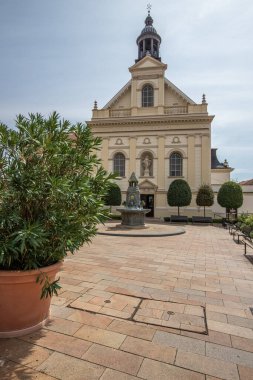 Beautiful city and street shot of an old town during the day. Summer weather in the city center at Szchenyi square, square with historical buildings in the five church city, Pcs Hungary clipart