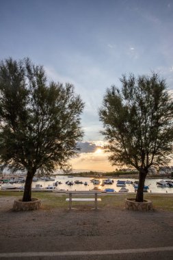 Sabahları küçük limanı olan bir sahil. Akdeniz 'de güzel bir gün doğumu. Vir, Zadar, Dalmaçya, Adriyatik Denizi, Hırvatistan 'ın Akdeniz kıyıları ve manzarası