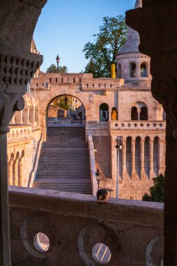 Old historical fortress and church in sunrise. City panorama at dusk. Sight on the Danube Fisherman's Bastion, Halszbstya, Budapest, Hungary clipart