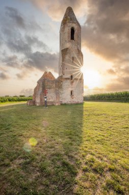 Old Catholic church, ruins in the middle of the corn field. Landscape shot at sunset Pusztatorony Hager, Somogyvmos Balaton, Hungary clipart