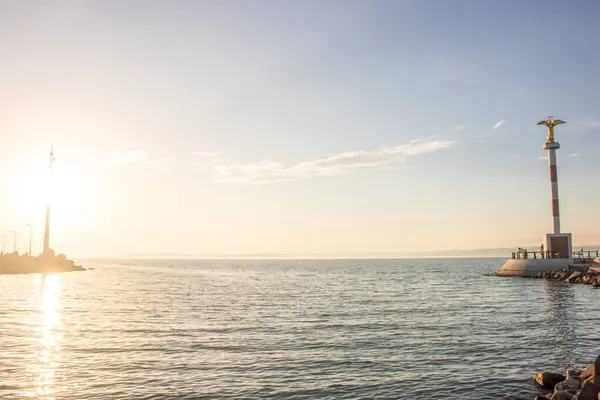 stock image Fantastic sunset on a large lake. Standing on the shore looking to the horizon across the lake into the sun. Romantic landscape shot at Lake Balaton, Hungary