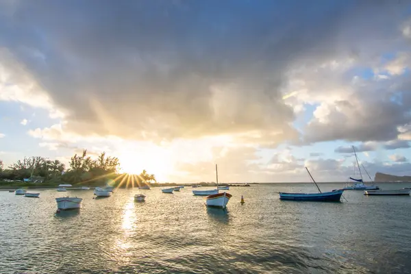 stock image Landscape with a view over a small harbor with fishing boats. Tropical landscape with sunset view at Cape Malheureux, Mauritius