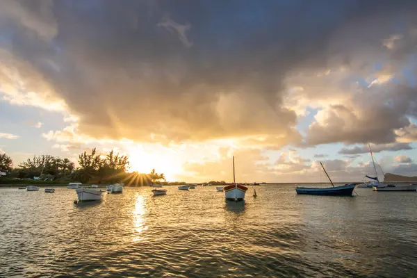 stock image Landscape with a view over a small harbor with fishing boats. Tropical landscape with sunset view at Cape Malheureux, Mauritius