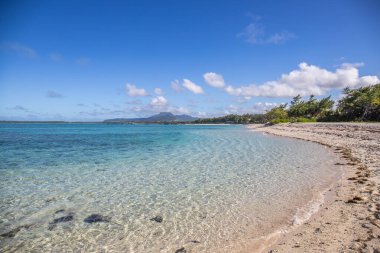 Sabahları kumlu harika bir sahil. Hint Okyanusu 'nda bir ada, deniz manzaralı fotoğraf ya da deniz manzaralı deniz manzaralı. Sahilde küçük lav kayaları var Trou d 'Eau Douce, Mauritius