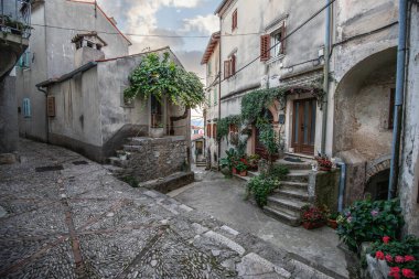 Eski, tarihi, rüya gibi dağ köyü. Dar sokaklar, romantik bir ortamda eski evler. Moenice, Moscenicka Draga, Istria, Hırvatistan küçük yolları ve meydanları olan güzel manzaralı bir yer.