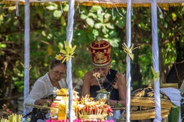 ceremony on the beach. Religious ceremony of Hindu faith on the beach of Sanur, Bali, Indonesia clipart