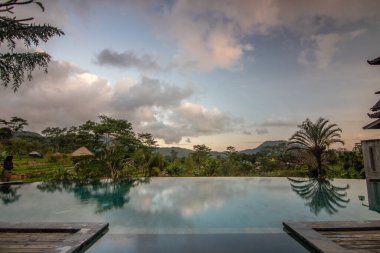 Small private hotel in the middle of the rice fields and rice terraces. Pure nature in the original and typical landscape of Sidemen, Bali, Indonesia clipart