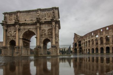 Rainy weather in the morning, sunrise in an old historic city. Beautiful details and historic Roman buildings of the Eternal City, Arco di Costantino, Rome, Italy clipart