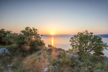 Akdeniz 'deki Akdeniz manzarası, sabah güneş doğarken çekildi. Akdeniz, Moenika Draga, Moscenicka Draga, Istria ve Hırvatistan 'da kayalıkları ve kayaları olan saf doğa.