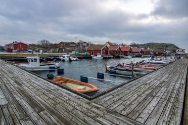 Beautiful village landscape in a fjord. Fishermen and restaurants in the evening at sunset. Boats and a beautiful landscape in Havstenssund, Sweden, Scandinavia clipart