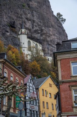 An old half-timbered town, in autumn. Here a church was built into a rock. Unique German architecture. Misty landscape in the morning at the Felsenkirche, Idar-Oberstein, Rhineland-Palatinate, Germany clipart