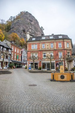 An old half-timbered town, in autumn. Here a church was built into a rock. Unique German architecture. Misty landscape in the morning at the Felsenkirche, Idar-Oberstein, Rhineland-Palatinate, Germany clipart