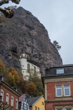 An old half-timbered town, in autumn. Here a church was built into a rock. Unique German architecture. Misty landscape in the morning at the Felsenkirche, Idar-Oberstein, Rhineland-Palatinate, Germany clipart