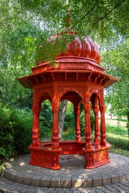 Beautiful summer evening in a park. Landscape shot in Krishna valley at sunset. Park and temple complex at Balaton, Unagrn clipart