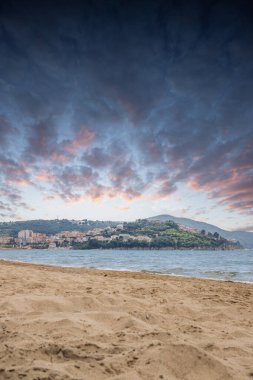 Arka planda tepeler olan sahil ve deniz güney İtalya 'da tatil köyü olan körfez ve kıyı.