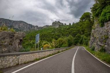 Kıyı manzarası fotoğrafı. Deniz boyunca uzanan ve çarpıcı yeşil Akdeniz manzarası boyunca uzanan bir yoldan manzara. Salerno, İtalya kıyıları