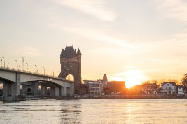 Eski tarihi bir şehir kapısından bir yol ya da otoyol geçiyor. Solucanlar, Almanya yakınlarındaki Ren nehrinde akşam üstü gün batımı