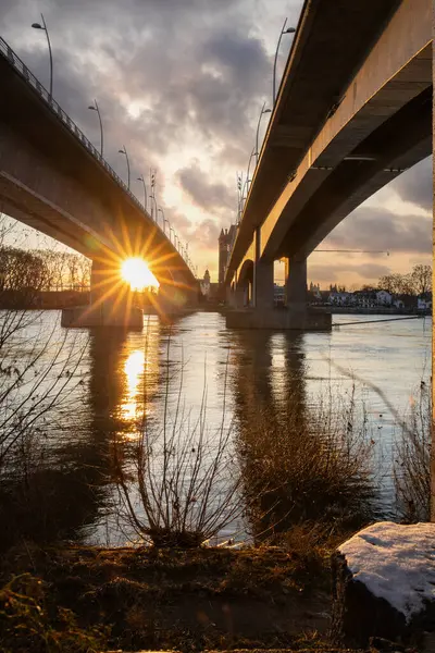 Eski tarihi bir şehir kapısından bir yol ya da otoyol geçiyor. Solucanlar, Almanya yakınlarındaki Ren nehrinde akşam üstü gün batımı