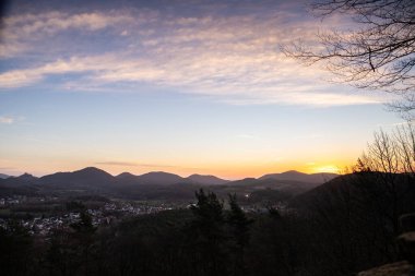 Sunrise on a rock. Landscape shot with a view over a forest and valley. Morning mood in nature. Landscape in the Palatinate Forest, Germany