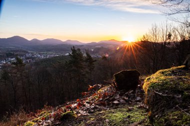 Sunrise on a rock. Landscape shot with a view over a forest and valley. Morning mood in nature. Landscape in the Palatinate Forest, Germany