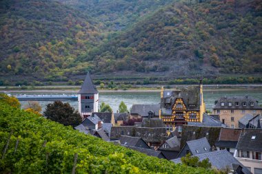 Eski, ahşap bir kasabaya bakın. Ren nehri boyunca çekilen bulutlu bir manzara. Alman Şarap Yolu, Bacharach, Almanya