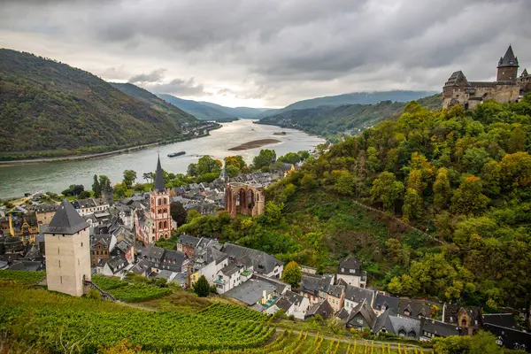 Eski, ahşap bir kasabaya bakın. Ren nehri boyunca çekilen bulutlu bir manzara. Alman Şarap Yolu, Bacharach, Almanya