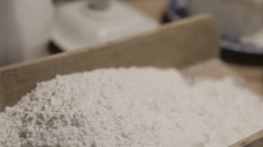 Flour in a scoop, butter and a bowl of yeast. Preparations for baking. High quality 4k footage
