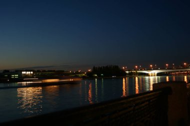 Night bridge across a large river. It is illuminated by spotlights. Video in good quality