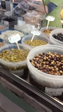 Portekiz 'deki markette kovalarda zeytin ve zeytin satılan buzdolabı tezgahı. Yüksek kaliteli FullHD görüntüler