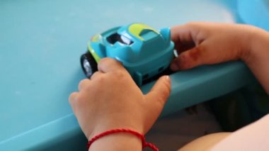 İki yıl boyunca bir çocuğun elleri, küçük yeşil bir masanın üzerinde küçük bir daktiloyla, en üstte, çerçevede küçük yeşil bir arabayla oynayan bir çocuk olmadan oynar.