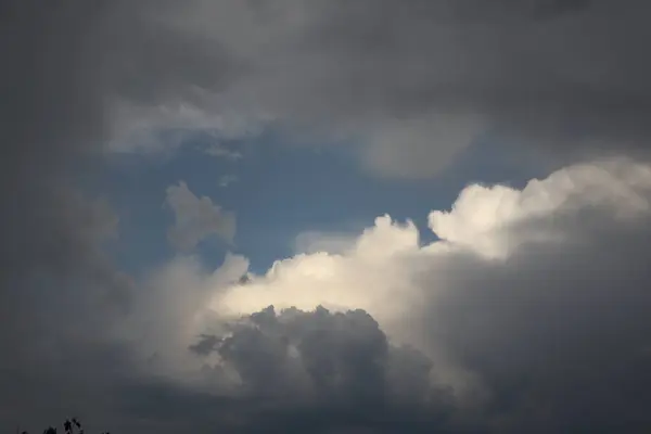 stock image A captivating scene of a dramatic sky with sunlight breaking through dark, stormy clouds is truly mesmerizing