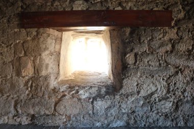 Tarihi mimarinin özünü gözler önüne seren sevimli küçük pencereli taştan bir duvar.