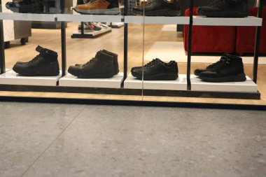 Featuring a diverse selection of stylish and fashionable black shoes displayed in an inviting retail setting clipart